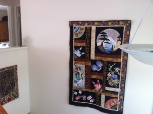 Scenes of the Orient quilt hanging in the entry.